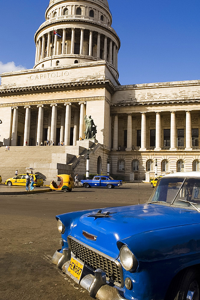 A blue vintage 1950's American Chevy in front of the Capitolio in central Havana, Cuba, West Indies, Central America