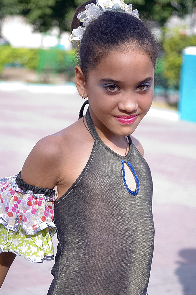 A school girl dressed in a colourful costume for a school festival, Santiago de Cuba, Cuba, West Indies, Central America