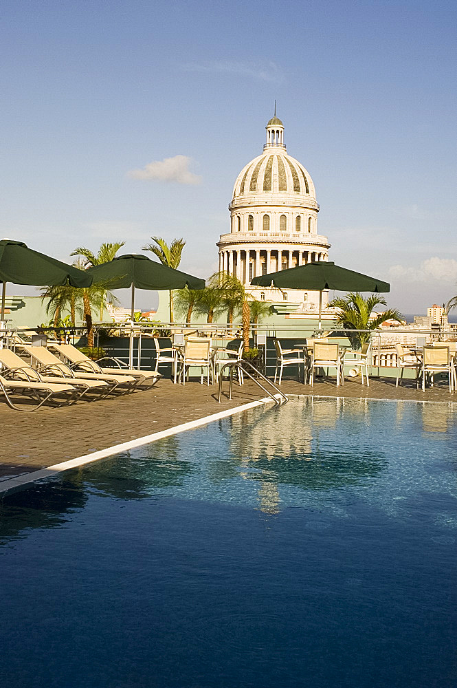 A swimming pool on the roof terrace of the Hotel Saratoga overlooking the Capitolio in central Havana, Cuba, West Indies, Central America