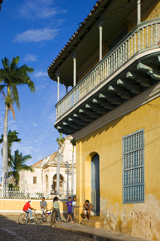 Cubans out on the cobbled street next to the Casa Ortiz, Trinidad, Cuba, West Indies, Central America