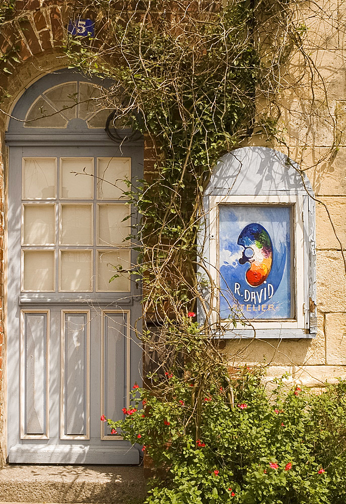 An artist's sign and old blue door in Beaumont en Auge, Pays d'Auge, Normandy, France, Europe