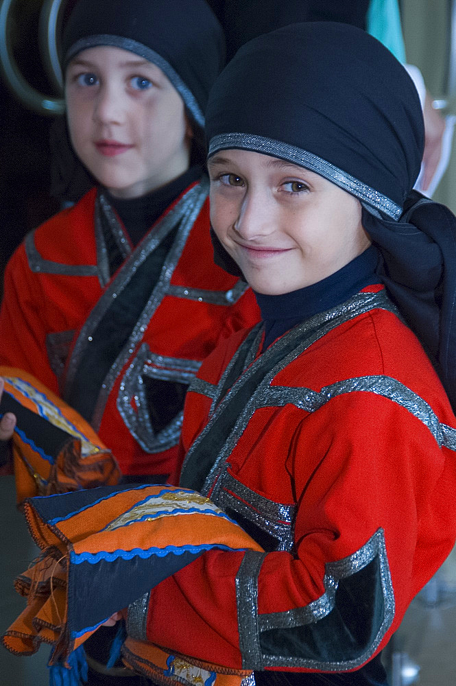 Two young boys in traditional costume preparing for a folk dance performance, Batumi, Georgia, Eurasia