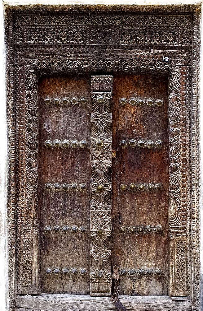 An intricately carved wooden Arab door in Stone Town, Zanzibar, Tanzania, East Africa