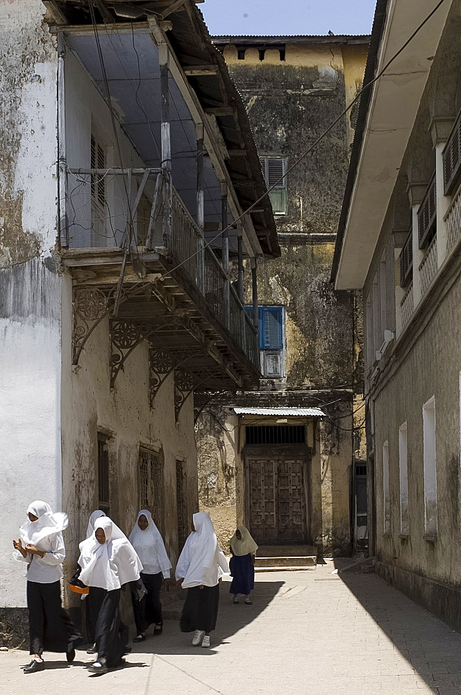 Schoolgirls in white headscarves walking in Stone Town, Zanzibar, Tanzania, East Africa, Africa