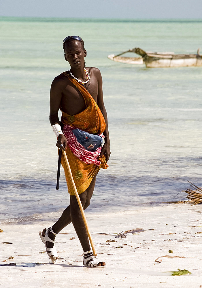 A Maasai tribesman on Paje Beach wearing colourful native dress, Paje, Zanzibar, Tanzania, East Africa, Africa