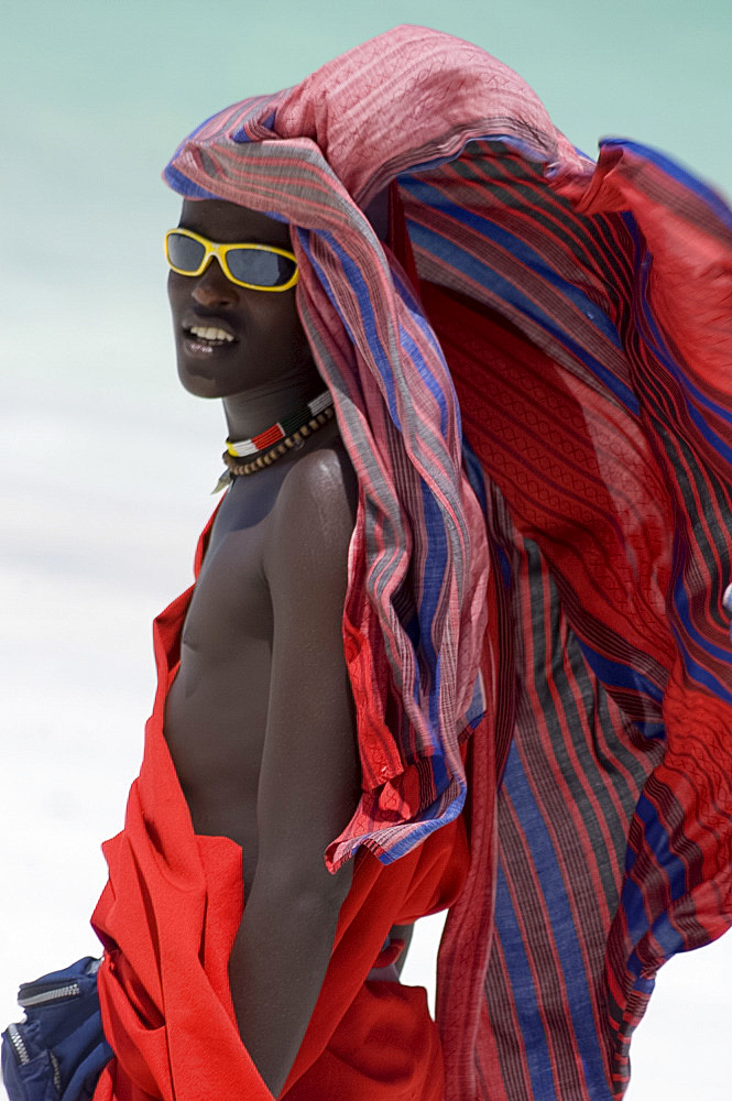 A Maasai tribesman on Paje Beach wearing colourful native dress, Paje, Zanzibar, Tanzania, East Africa, Africa