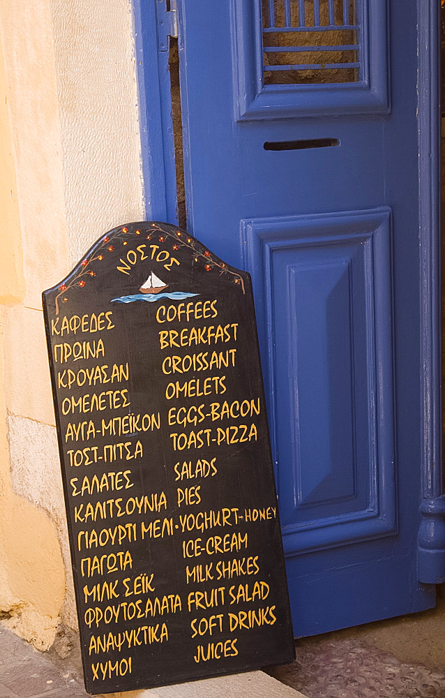 A chalkboard menu outside a taverna on a small back street in Hania, Crete, Greek Islands, Greece, Europe