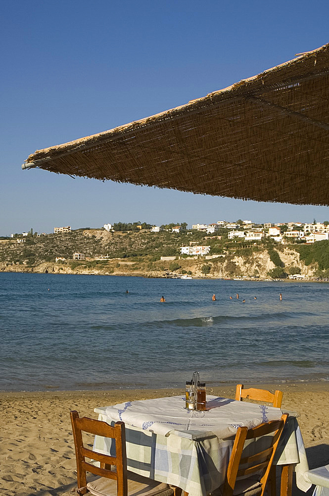 A seafront taverna in the resort town of Plaka on the north coast of Crete, Greek Islands, Greece, Europe