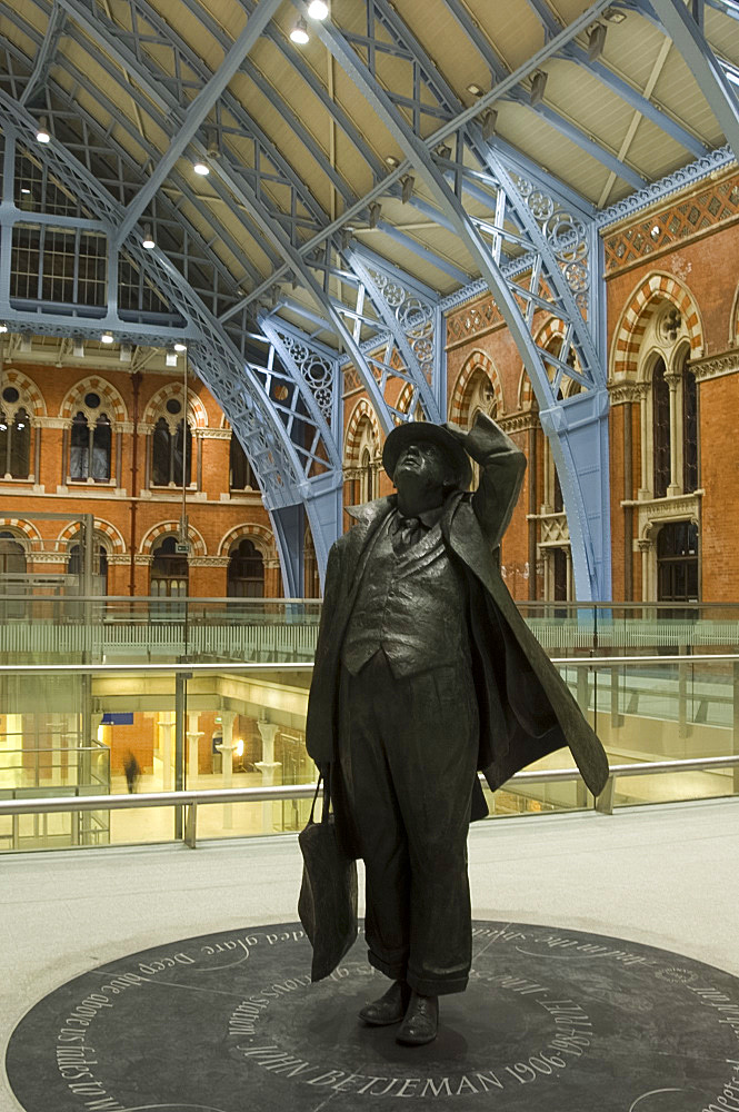 A statue of the writer and saver of St. Pancras Station, Sir John Betjeman, in newly renovated station, London, England, United Kingdom, Europe