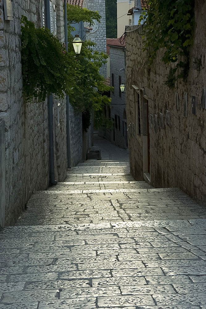 Worn stone steps between high walls in Rab Town, island of Rab, Kvarner region, Croatia, Europe