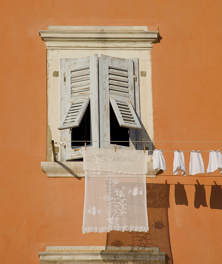 Laundry hanging from a shuttered window in Rovinj, Istria, Croatia, Europe