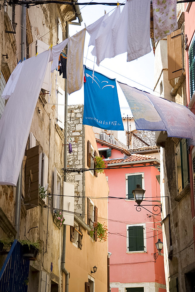 Laundry hanging in an alley of old buildings in Rovinj, Istria, Croatia, Europe