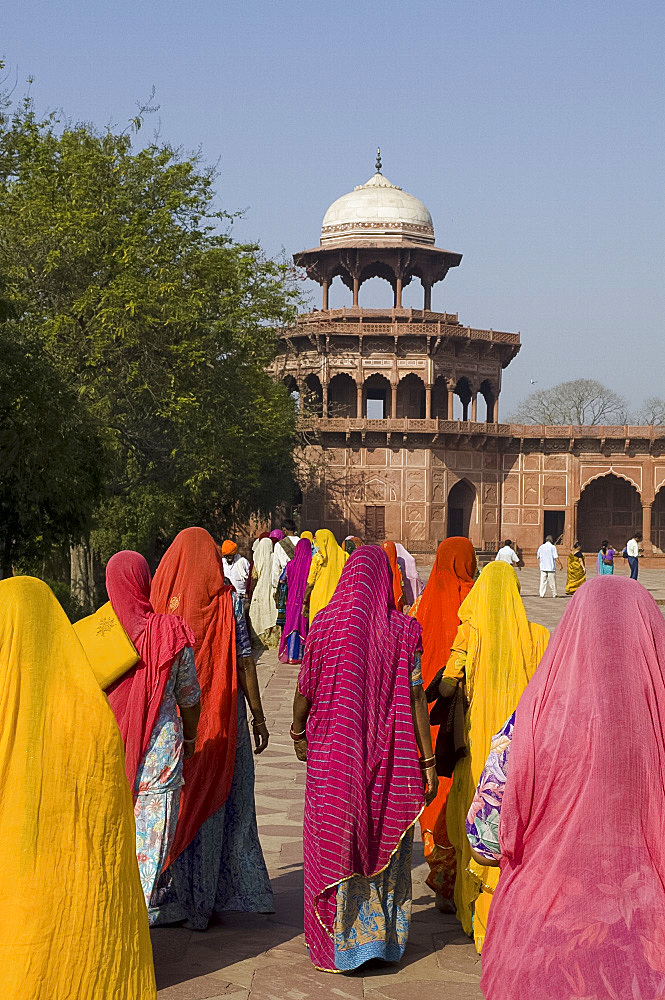 Indian women in brightly coloured saris at the Taj Mahal, Agra, Uttar Pradesh, India, Asia