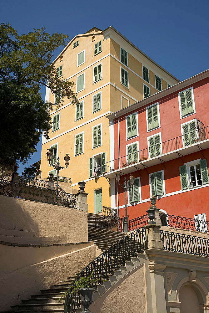 A grand staircase and iron railing leading to colourful old buildings in the Terra Nova section of Bastia, Corsica, France, Europe