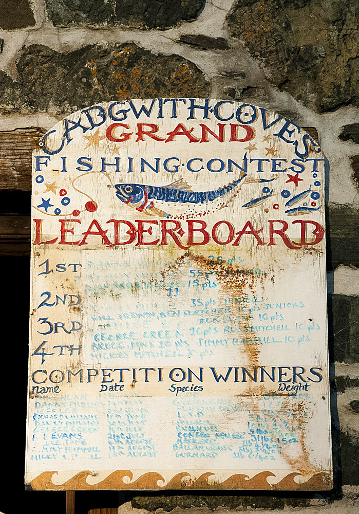 An old painted wooden sign in Cadgwith Harbour on the Lizard Peninsula in Cornwall, England, United Kingdom, Europe