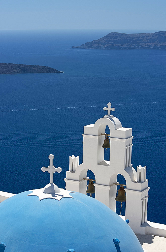 A blue domed Greek Orthodox church overlooking the sea in Firostefani, Santorini, The Cyclades, The Aegean, Greek Islands, Greece, Europe