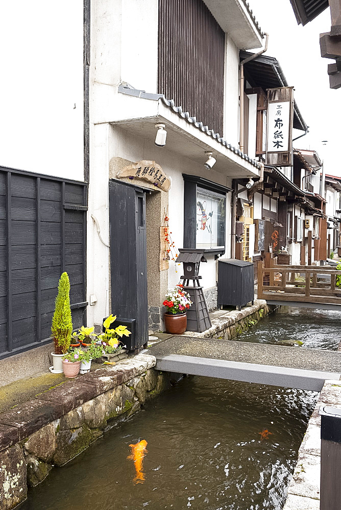 Traditional old Japanese houses on White Walled Storehouse Street along the carp filled Setogawa Canal in Hida Furukawa, Gifu Prefecture, Honshu, Japan, Asia