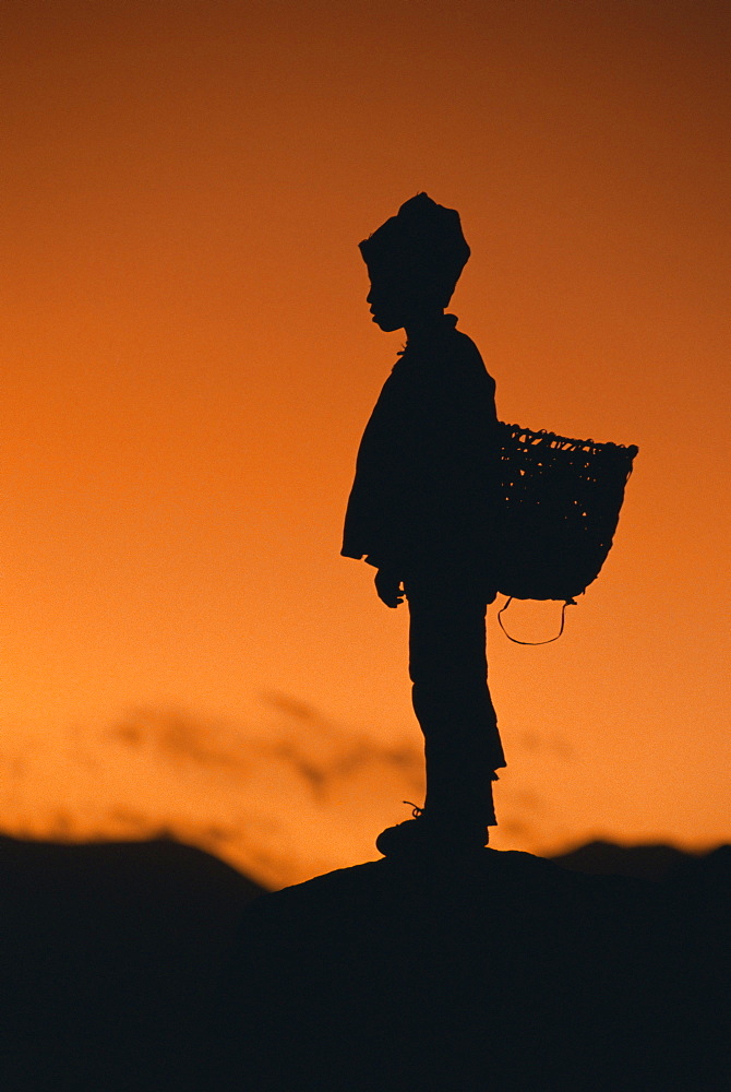 Silhouette of local boy at sunset, Everest Base Camp Trek, Nepal, Asia