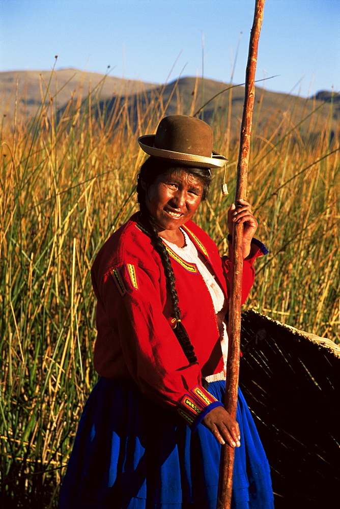 Uros Indian woman in traditional reed boat, Islas Flotantes, Lake Titicaca, Peru, South America