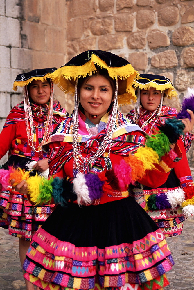 Portrait of three local Peruvian girls in traditional dance dress, looking at the camera, Cuzco, Peru, South America