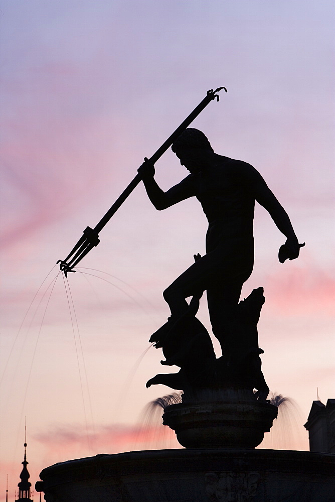 The Neptune Fountain, silhouetted at dusk, Dlugi Targ (Long Market), Gdansk, Pomerania, Poland, Europe