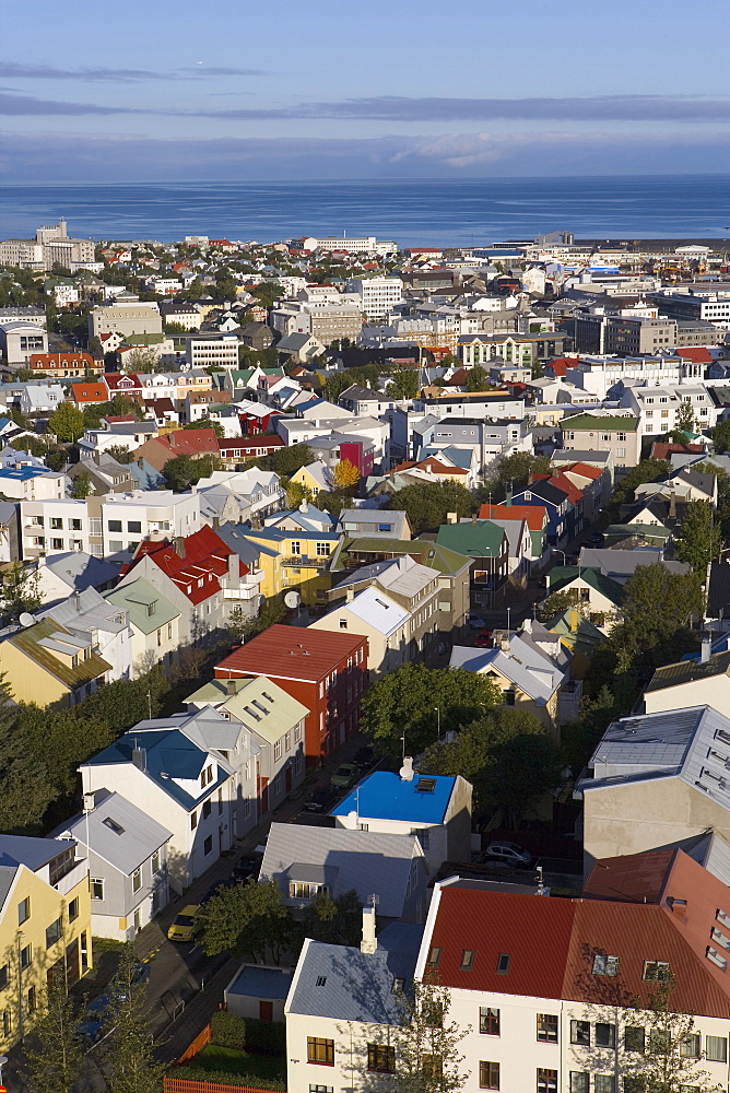 Low aerial view from Hallgrimskirkja of colourful houses, commercial buildings and harbour of the capital city, Reykjavik, Iceland, Polar Regions