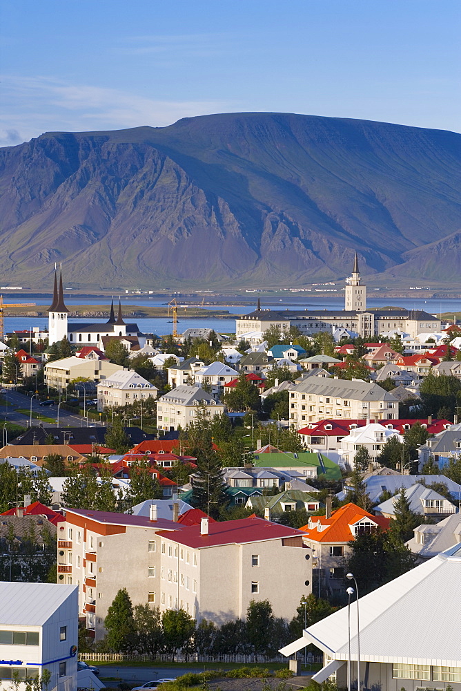 View from the Perlan of colourful houses, commercial buildings, churches and harbour of the city, with mountains beyond, Reykjavik, Iceland, Polar Regions