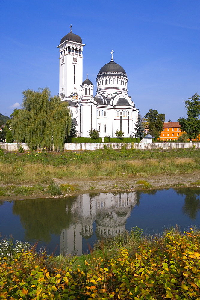 St. Treime Orthodox church on the banks of the river Tarnava Mare in the medieval citadel town, Sighisoara, Transylvania, Romania, Europe