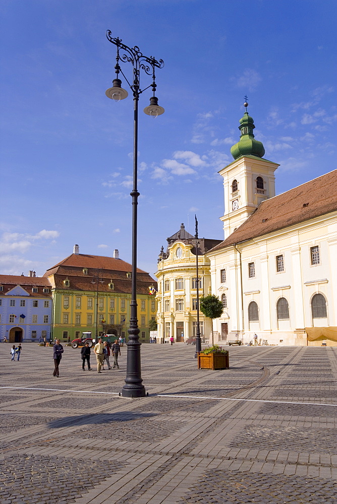 Colourfully painted houses and buildings surrounding the main old town square, Piata Mare, in the 12th century Saxon city, Sibiu, Transylvania, Romania, Europe