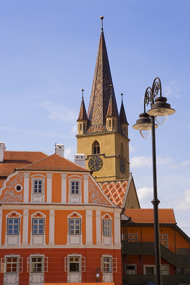 Colourfully painted houses and the Evangelical church, Piata Huet, in the 12th century Saxon city, Sibiu, Transylvania, Romania, Europe