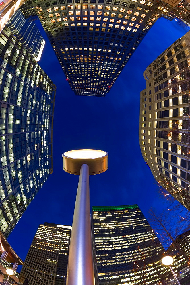 Financial District office buildings illuminated at dusk, Canary Wharf, Docklands, London, England, United Kingdom, Europe