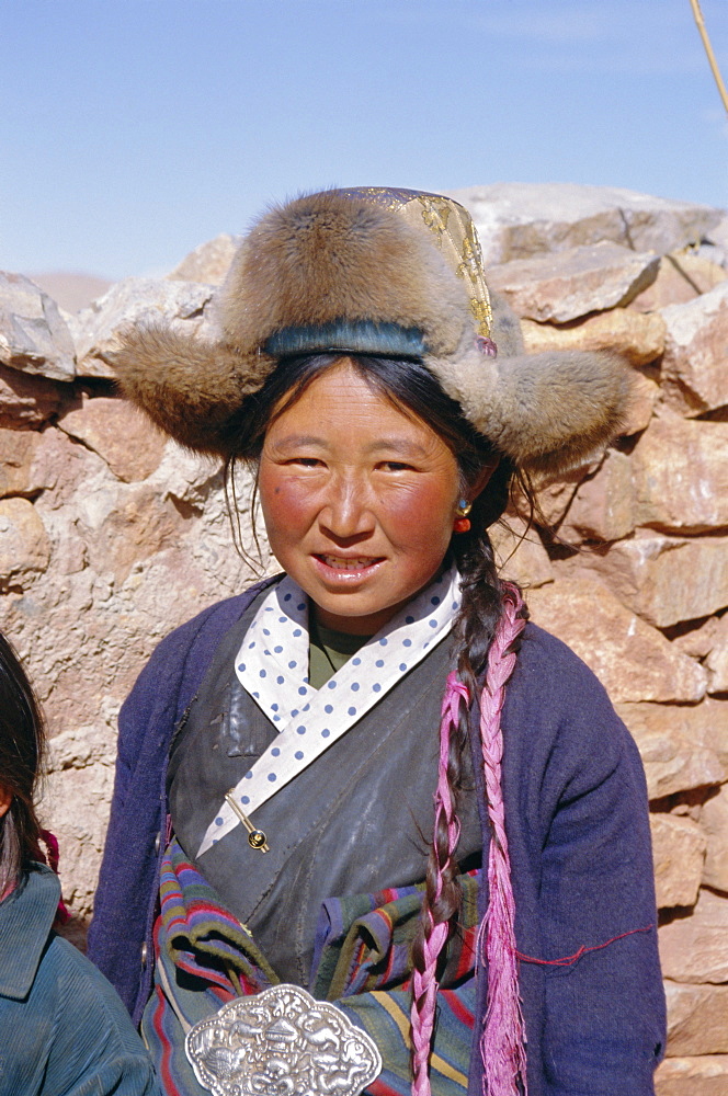 Portrait of a village woman wearing fur trimmed hat, Tibet, China, Asia