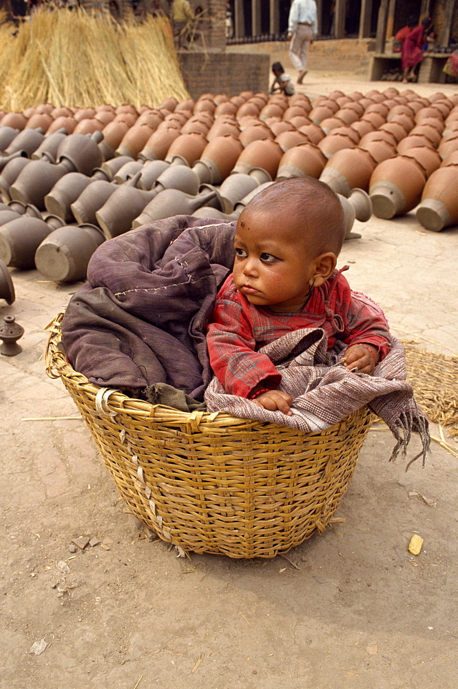 Baby in a wicker basket at Bhaktapur in Nepal, Asia