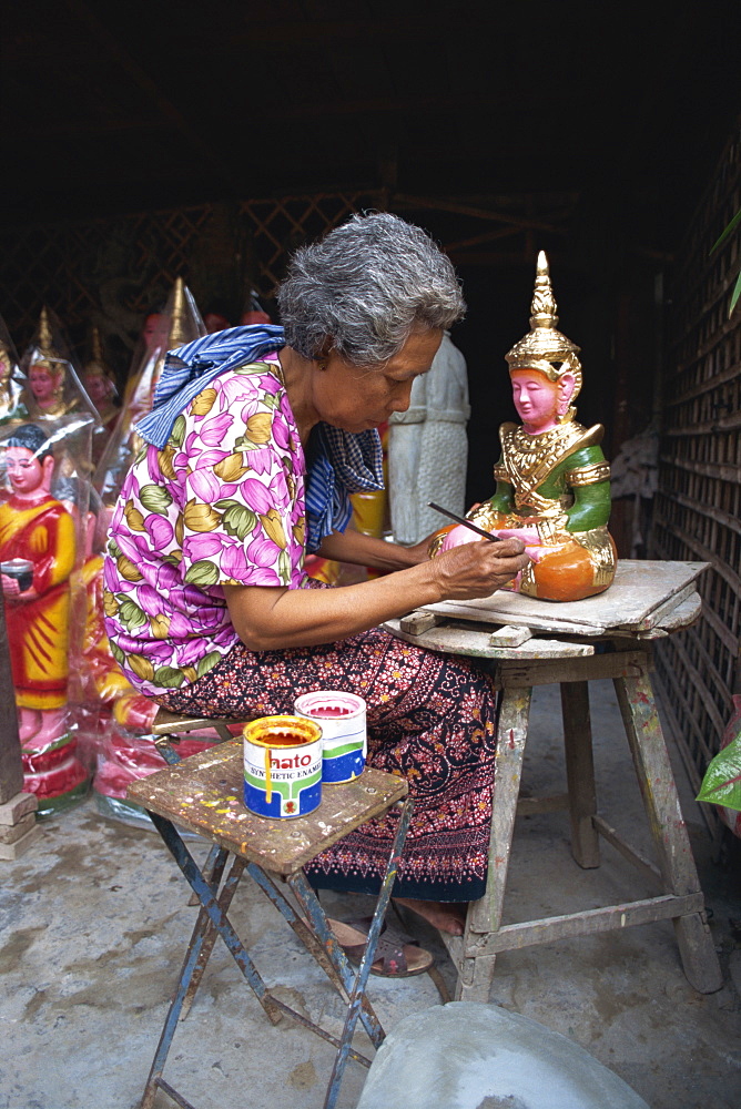 A woman painting artifacts for temples destroyed by the Khmer Rouge in Phnom Penh, Cambodia, Indochina, Southeast Asia, Asia