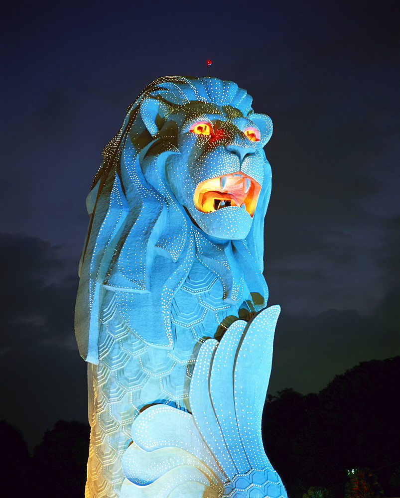 The Merlion statue, the symbol of Singapore, in turquoise light at night in Singapore, Southeast Asia, Asia