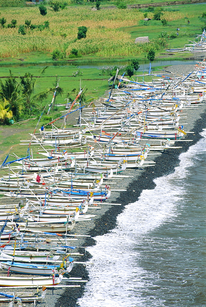 Colourful prahu (fishing boats) lining the beach, Amed, Bali, Indonesia