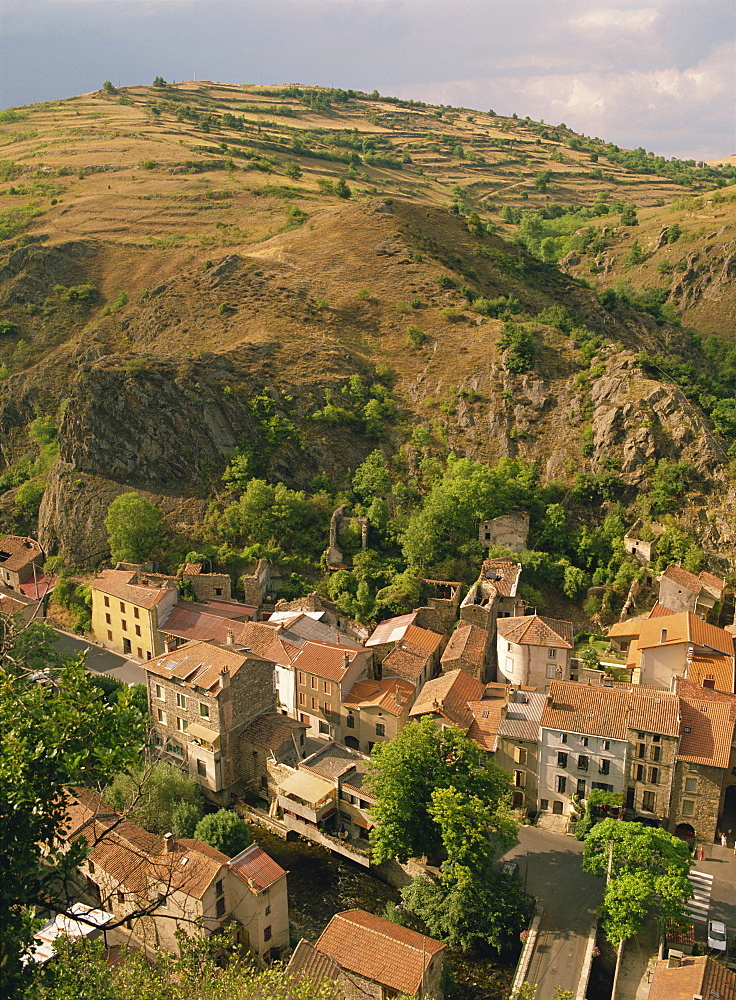 Houses of the village of St. Floret in the Couze de Pavin Valley, with hill behind, near Issoire, in the Puy de Dome, Auvergne, France, Europe