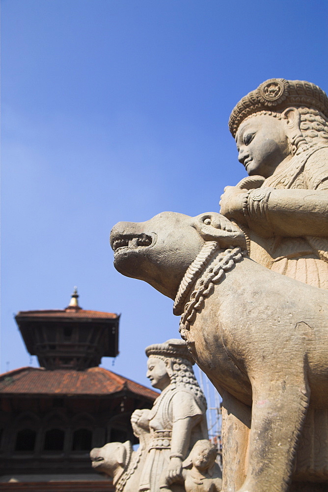 Stone statues guard Durga temple, Bhaktapur, Nepal, Asia