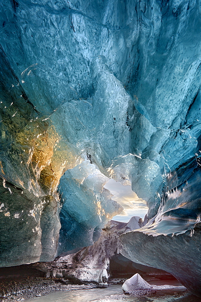 View inside an ice cave under the south Vatnajokull Glacier, captured at sunrise during winter when the ice caves are accessible, near Jokulsarlon, Southern Iceland, Iceland, Polar Regions