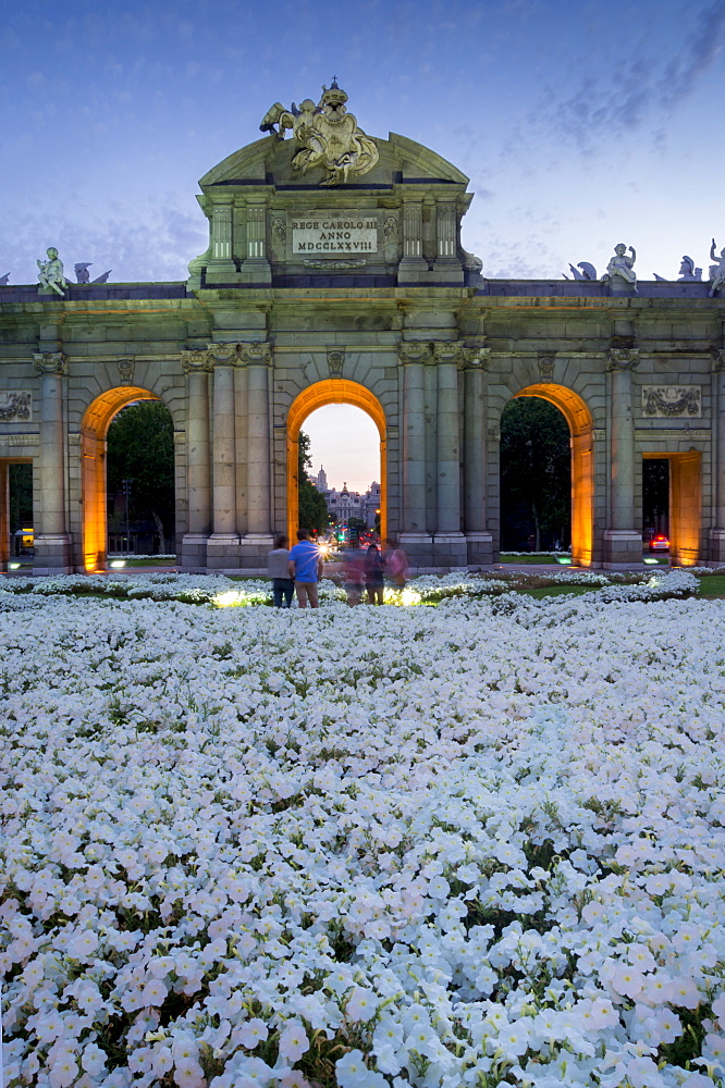 Puerto de Alcala at dusk and white flowerbed, Madrid, Spain, Europe