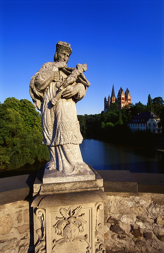 Statue on the Old Lahn-Bridge and a Cathedral in Limburg,  Germany