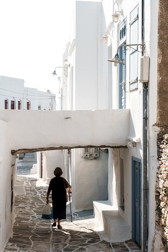 Old lady in black with stick and shopping walking home, Kastro Village, Sifnos, Cyclades, Greek Islands, Greece, Europe