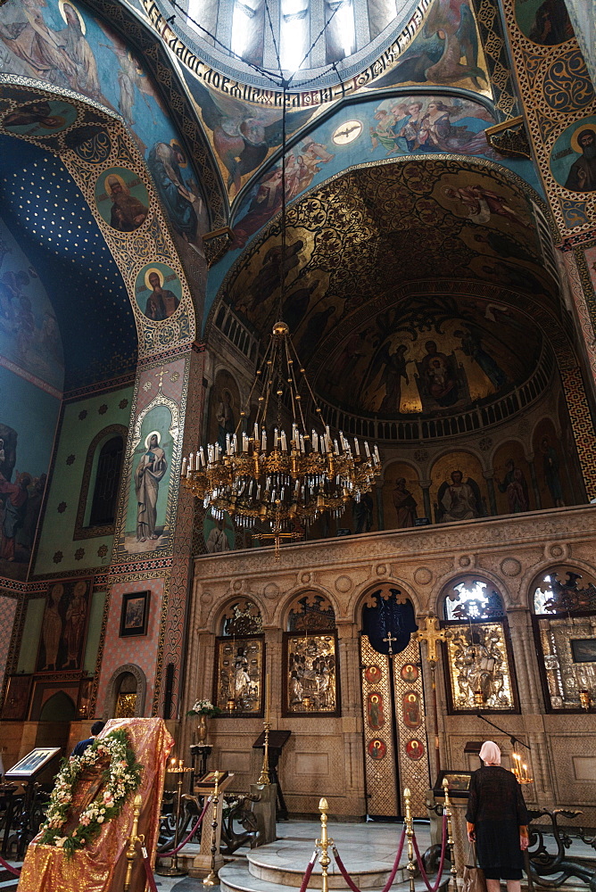 Worshipper at the altar of Sioni Cathedral, original built in 6th and 7th centuries, Old Town, Tbilisi, Georgia, Central Asia, Asia