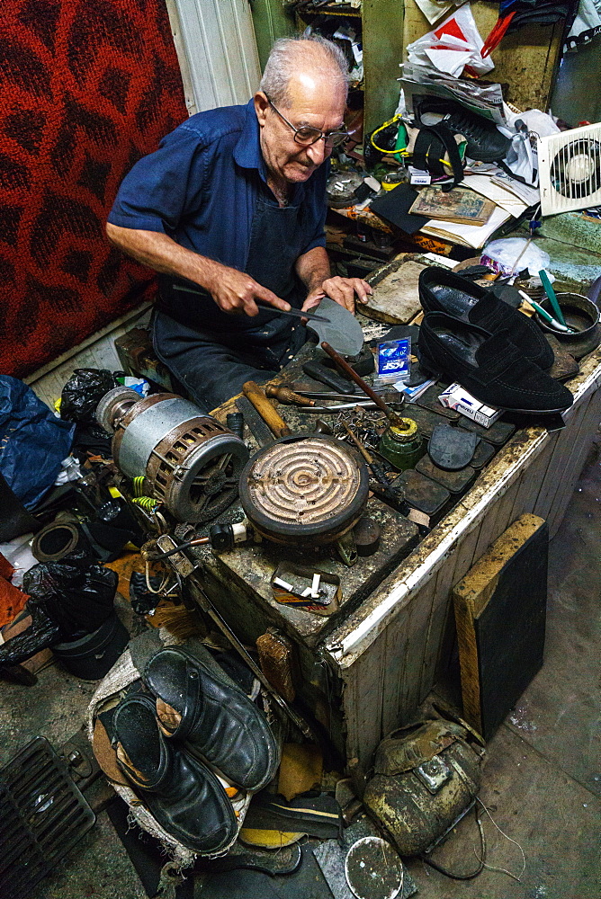 Armenian shoe repairer at work in his shop on Jerusalem Street, Old Town, Tbilisi, Georgia, Central Asia, Asia