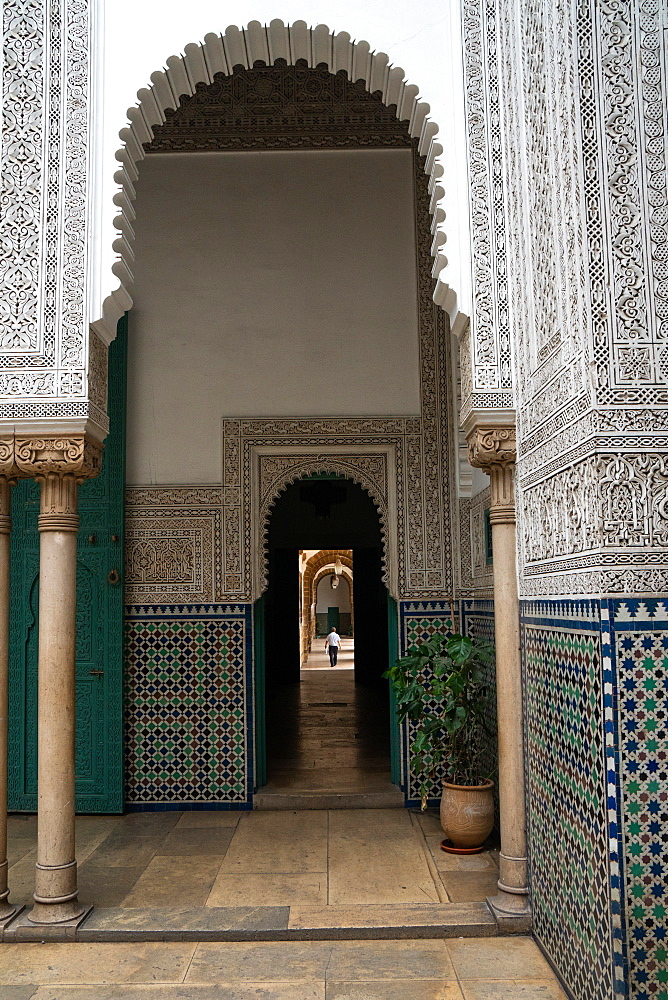 Man wanders down a long corridor decorated in Moorish style, Mahkama du Pacha, former Law Courts, Casablanca, Morocco, North Africa, Africa