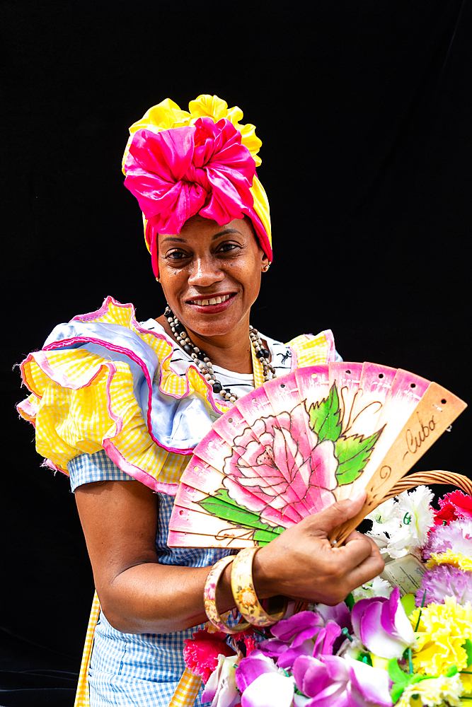 Colourful flower girl with headdress, fan and basket, Havana, Cuba (Model Release) 2