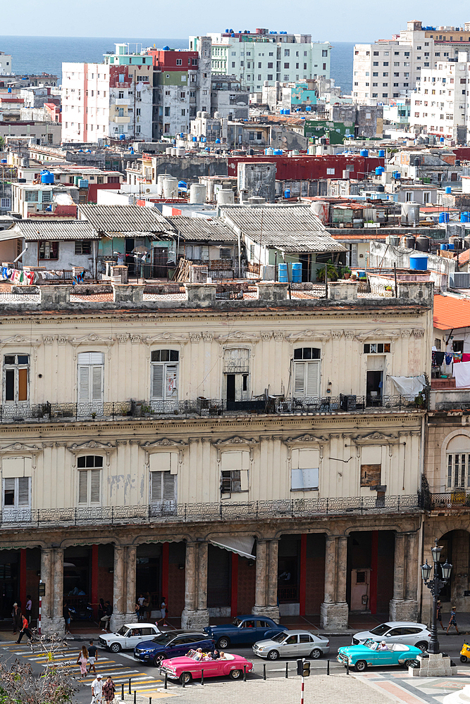 Aerial view of the dividing streets between Modern and Old Havana, classic cars in foreground, Cuba 3