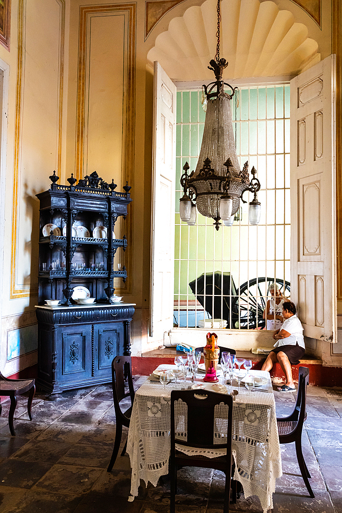 Sharing gossip in dining room of C19th sugar and railway baron's mansion, Palacio Cantero, Trinidad, Cuba