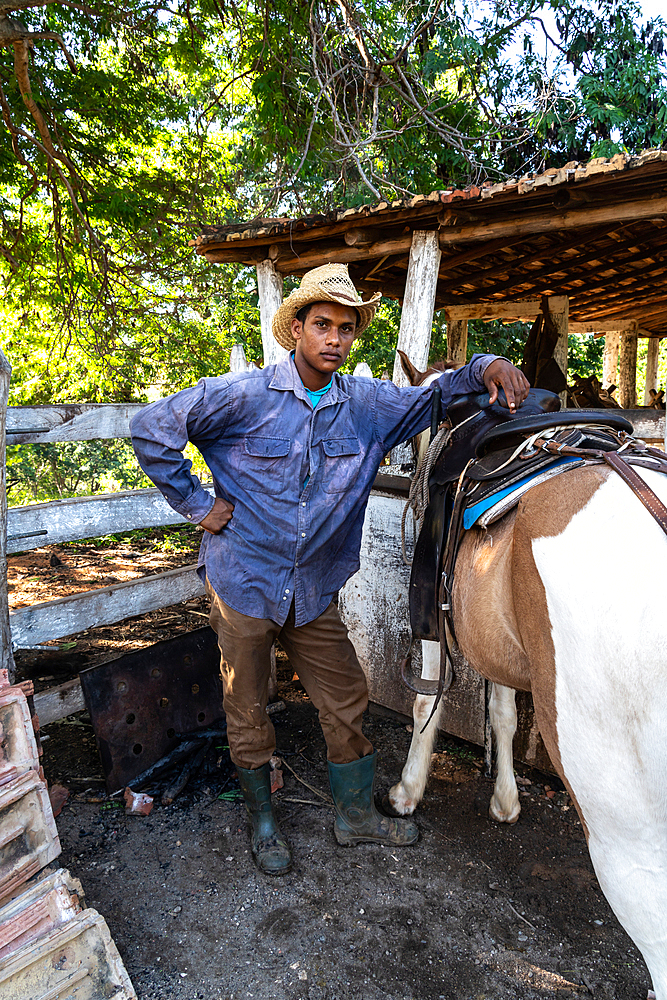 Cowboy with his horse at a farm near Trinidad, Cuba 1 (Model Release)