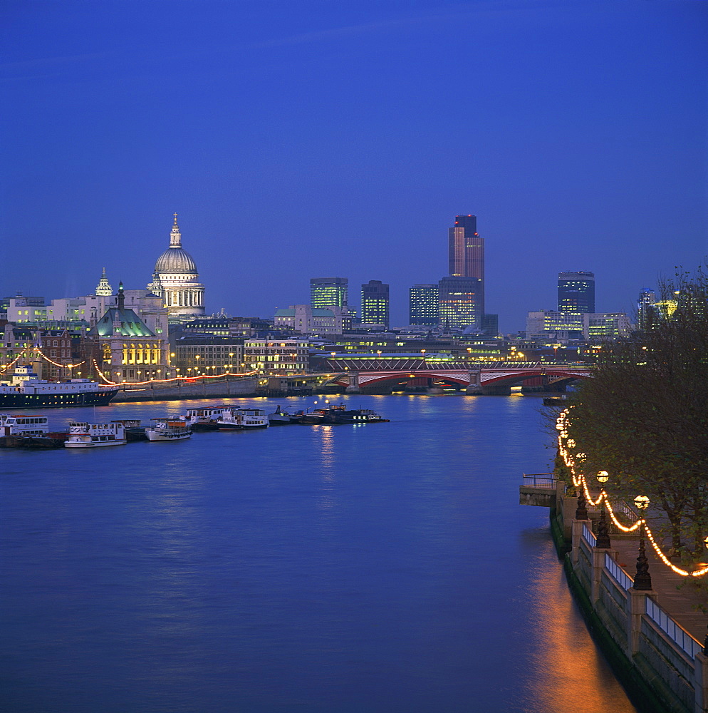 City skyline, including St. Paul's Cathedral, the NatWest Tower and Southwark Bridge, from across the Thames at dusk, London, England, United Kingdom, Europe